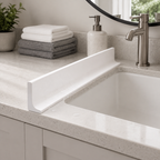 White silicone water splash guard installed along a bathroom countertop to help control water